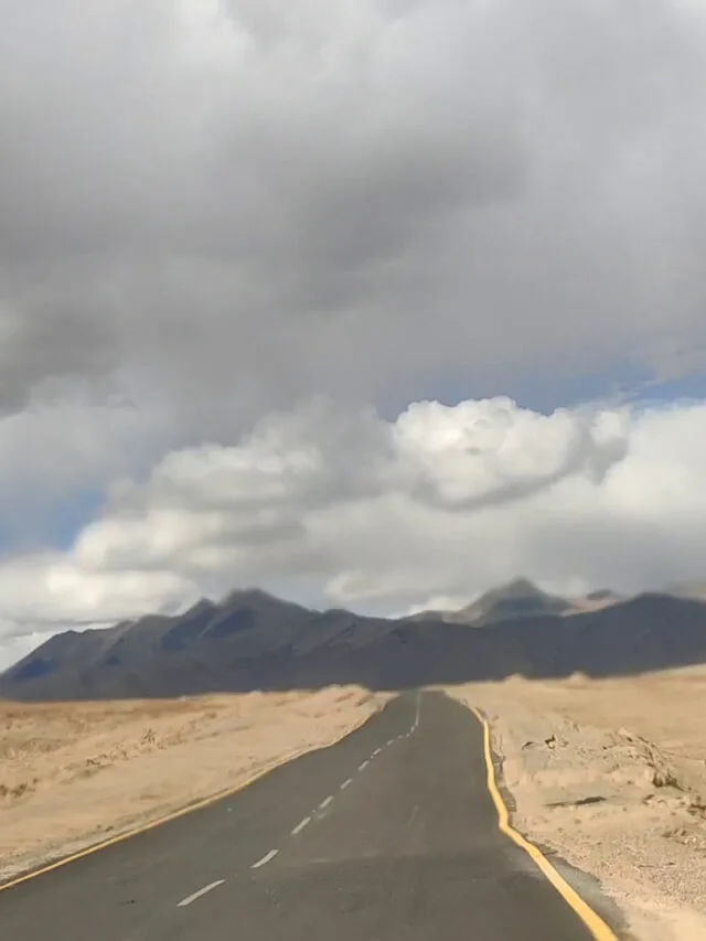 moray plains road in mountains cloudy sky and well paved road