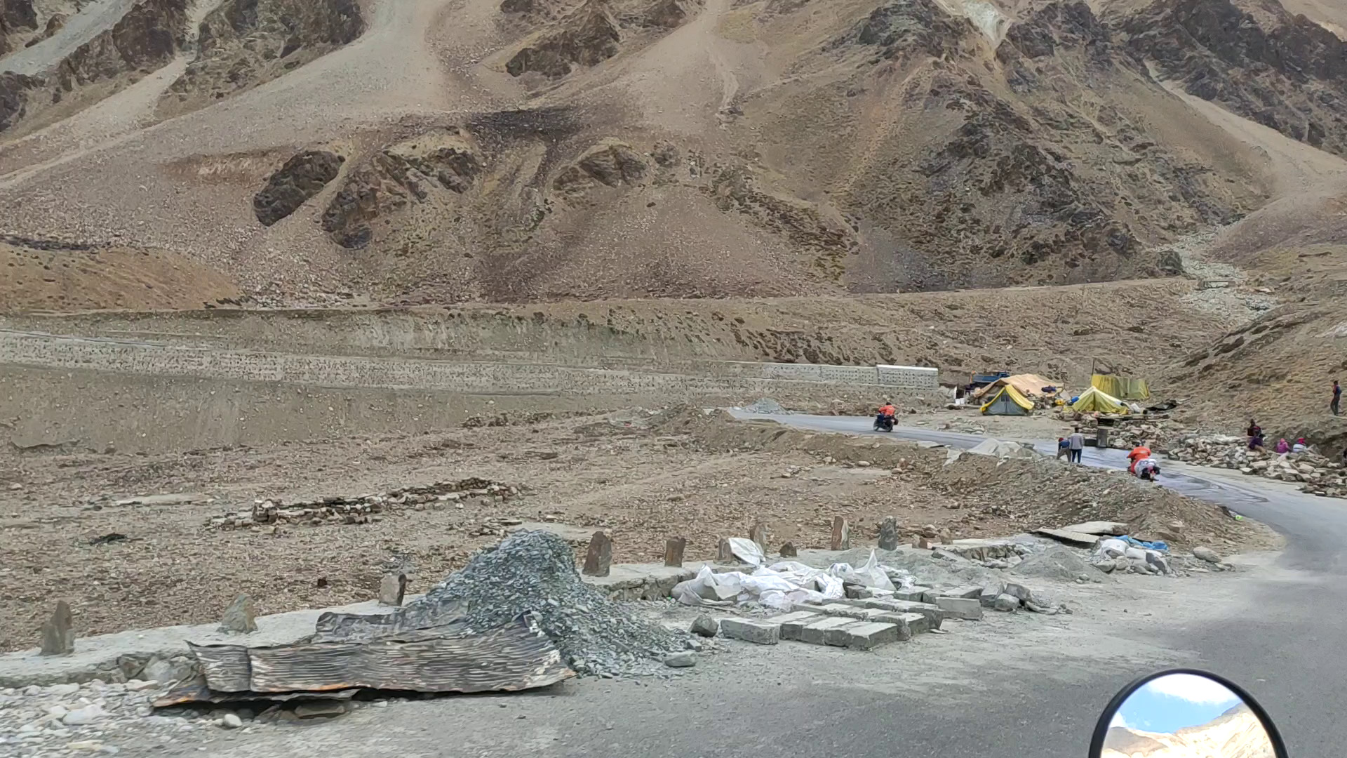 road in mountains with some riders on bike approaching towards whisky nala