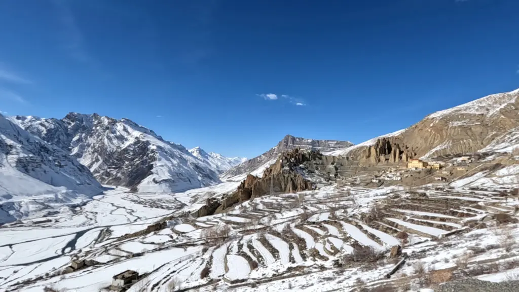 winter view of dhankar village snow covered mountains blue sky