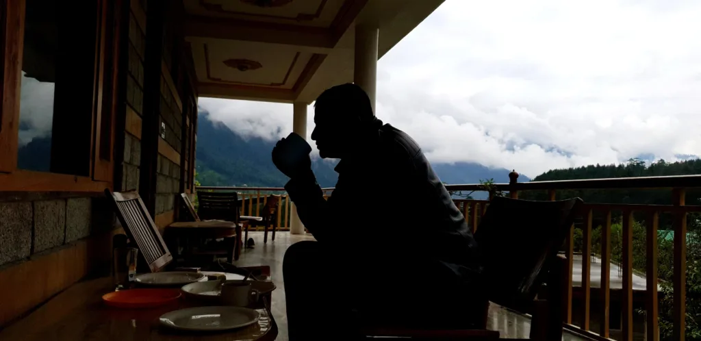 finding the right accommodation artcle banner man sitting and sipping tea in a hotels balcony