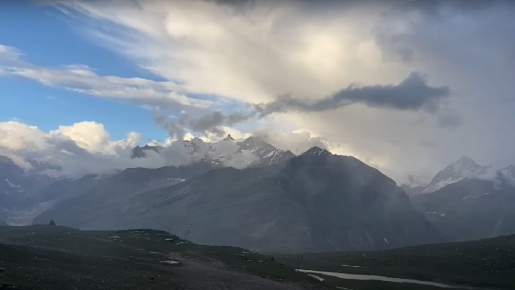 snow covered mountains clouds and blue sky view from rohtang pass Places To Visit Near Manali
