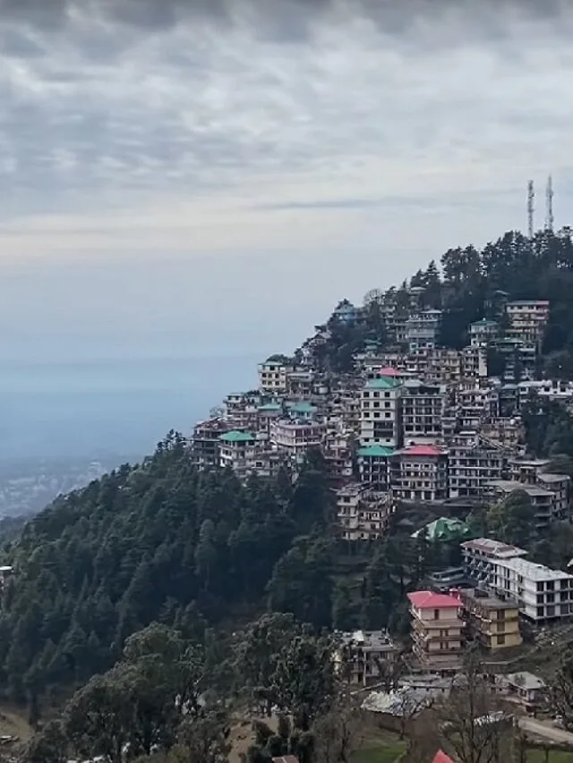 view of mcleodganj town green mountains blue sky