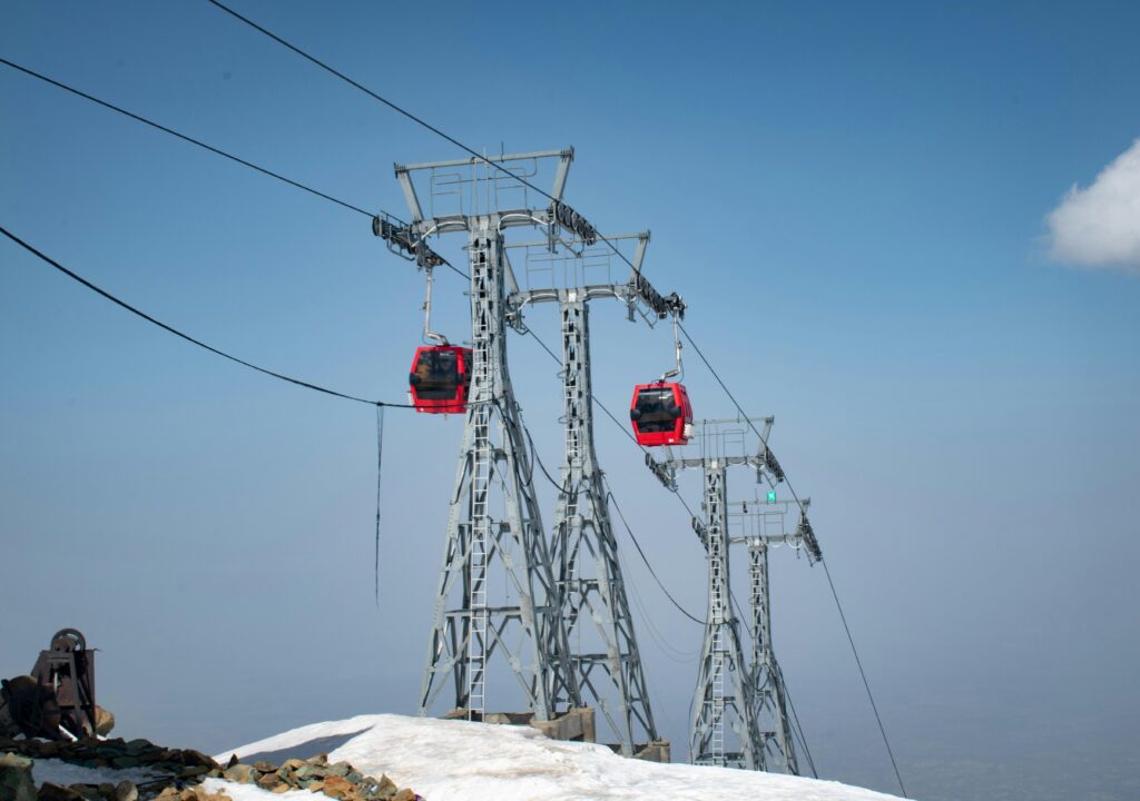 pexels-photo-31569983-31569983 Scenic view of Gulmarg Gondola cable cars against a snowy landscape and clear sky.