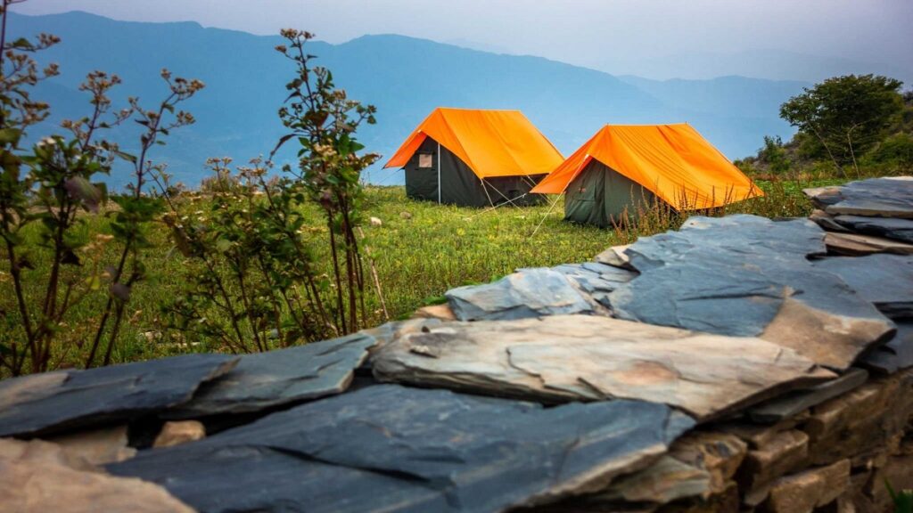 Nag-Tibba-Trek campsite on nag tibba trek in uttarakhand, mountains and blue sky