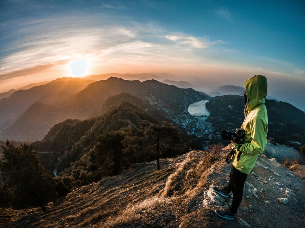 nainitall view A lone adventurer photographs the breathtaking sunrise over Nainital's mountains.